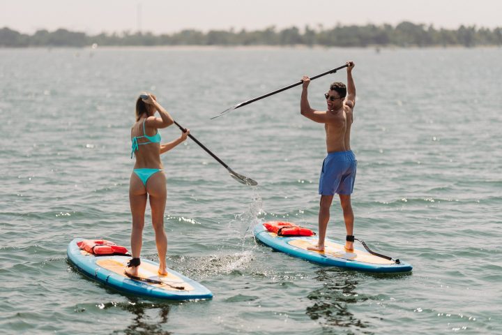 a girl riding a wave on a surfboard in the water