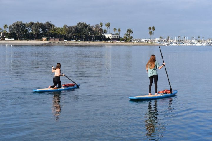 a group of people rowing a boat in a body of water