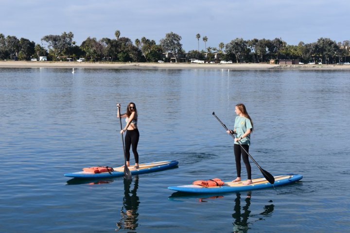 a group of people rowing a boat in a body of water