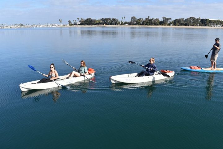 a group of people in a small boat in a body of water