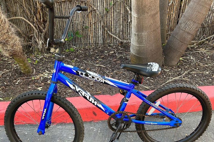 a bicycle is parked near a fence