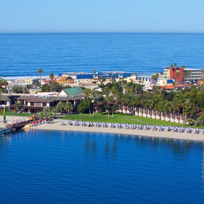a group of people swimming in a harbor next to a body of water