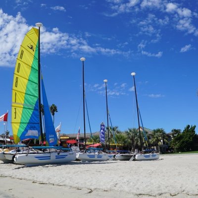 a boat sitting on top of a sandy beach