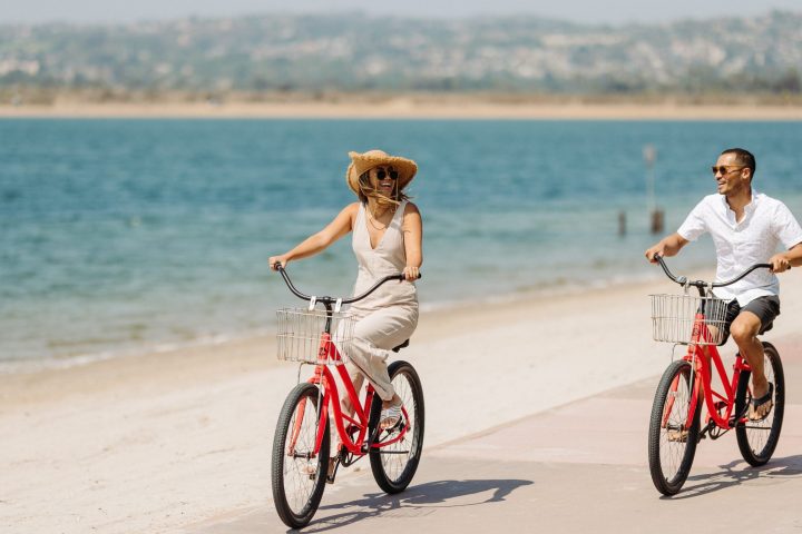 a person riding a bicycle on a beach