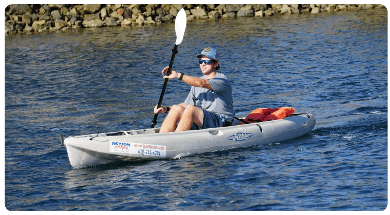a man riding on the back of a boat in a body of water